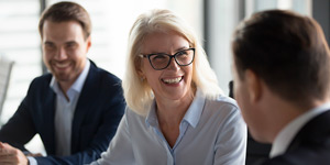 Picture of three people at a office meeting