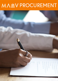 A close-up photo of a person's hand writing on paper