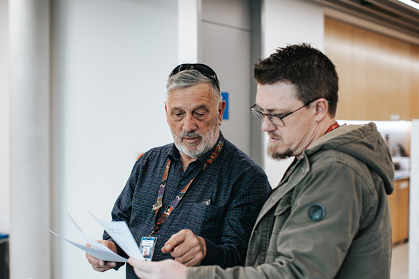 Two council officers checking a document