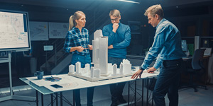 People of people discussing a 3D model of a city