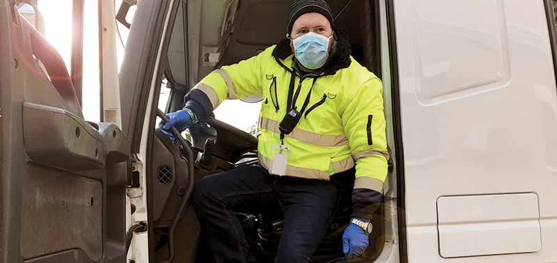 Man, wearing a mask disembarks from truck